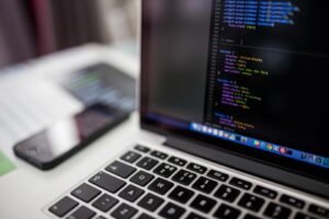 Laptop showing website code for a comparison of website design platforms in Saudi Arabia