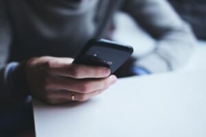 Hands texting on a smartphone, representing WhatsApp leads from Meta Ads