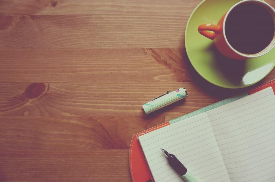 Notebook and coffee on a desk