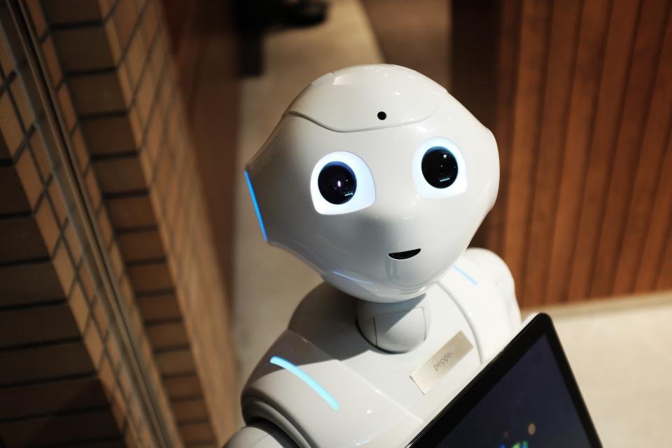 White humanoid robot representing AI assistants like ChatGPT recommending businesses